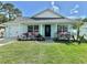 Charming single-story home featuring a cozy front porch and well-manicured lawn at 33635 Jeffery Ct, Leesburg, FL 34788