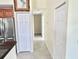 Bright hallway with tiled floors, white doors, and neutral walls offers a clean and spacious feel at 33635 Jeffery Ct, Leesburg, FL 34788
