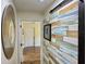 Hallway with unique wood accent wall, and decorative mirror at 33635 Jeffery Ct, Leesburg, FL 34788