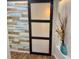 Hallway with sliding barn door and ocean themed decoration on the wall at 33635 Jeffery Ct, Leesburg, FL 34788