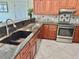 Gourmet kitchen featuring granite countertops, stainless steel appliances, and undermount sink at 33635 Jeffery Ct, Leesburg, FL 34788