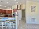 An open kitchen leading to a dining table and bar with stainless steel appliances at 33635 Jeffery Ct, Leesburg, FL 34788