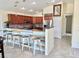 Stylish kitchen with a breakfast bar adorned with reclaimed wood and seating for three, enhancing the home's charm at 33635 Jeffery Ct, Leesburg, FL 34788
