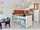Open kitchen featuring a breakfast bar, pendant lighting, and stainless steel appliances at 33635 Jeffery Ct, Leesburg, FL 34788