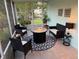 Cozy screened lanai with fire pit and comfortable seating, perfect for outdoor gatherings at 33635 Jeffery Ct, Leesburg, FL 34788