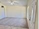 Bright open living room, with neutral carpet, ceiling fan, and front door at 33635 Jeffery Ct, Leesburg, FL 34788