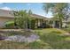The home features a private, tree-lined backyard and covered patio at 340 Juniper Way, Tavares, FL 32778