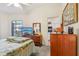Comfortable bedroom featuring a television and view to the kitchen at 340 Juniper Way, Tavares, FL 32778