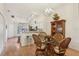 Dining area features a glass table, four woven chairs, and views into the kitchen at 340 Juniper Way, Tavares, FL 32778