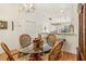 Glass dining table with woven chairs adjacent to the kitchen with stainless appliances at 340 Juniper Way, Tavares, FL 32778