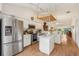 Open concept kitchen featuring stainless steel appliances, island and breakfast bar at 340 Juniper Way, Tavares, FL 32778