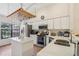 Well-lit kitchen featuring modern appliances, quartz countertop island, and lots of storage at 340 Juniper Way, Tavares, FL 32778
