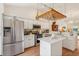 Light and airy kitchen boasting stainless steel appliances and quartz countertops at 340 Juniper Way, Tavares, FL 32778