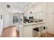 Bright kitchen features stainless steel appliances, center island, breakfast bar, and track lighting at 340 Juniper Way, Tavares, FL 32778