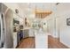 Open concept kitchen with stainless steel appliances, island, and adjacent dining area at 340 Juniper Way, Tavares, FL 32778