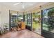 Bright lanai with wood floors, large windows, and a backyard view at 340 Juniper Way, Tavares, FL 32778