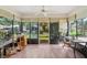 Bright lanai with wood floors, large windows, and a view of the backyard at 340 Juniper Way, Tavares, FL 32778