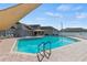 Community pool with sunshade featuring steps, ladders, and hot tub at 340 Juniper Way, Tavares, FL 32778