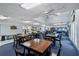 Spacious recreation room featuring tables, chairs, and golf score board at 340 Juniper Way, Tavares, FL 32778