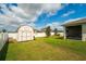 Backyard with a large shed and white fence at 37045 Scenic Ridge Dr, Grand Island, FL 32735