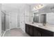 Bright bathroom featuring double sinks and a glass-enclosed shower at 37045 Scenic Ridge Dr, Grand Island, FL 32735