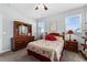 Bedroom with a ceiling fan, two windows, and a queen-sized bed at 37045 Scenic Ridge Dr, Grand Island, FL 32735