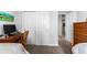 Bedroom features closet doors, neutral walls and wood-look floors extending into hallway at 37045 Scenic Ridge Dr, Grand Island, FL 32735