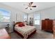 Cozy bedroom with a ceiling fan, two windows, and a queen-sized bed at 37045 Scenic Ridge Dr, Grand Island, FL 32735