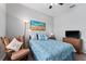 Bedroom showcasing a beach themed painting and cozy armchair at 37045 Scenic Ridge Dr, Grand Island, FL 32735