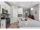 Modern kitchen featuring stainless steel appliances, granite countertops, and sleek white cabinetry at 37045 Scenic Ridge Dr, Grand Island, FL 32735