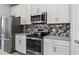 Close up of a kitchen with stainless steel appliances and a mosaic backsplash at 37045 Scenic Ridge Dr, Grand Island, FL 32735