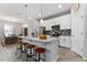 Bright kitchen with a center island, pendant lights, white cabinets, and stainless steel appliances at 37045 Scenic Ridge Dr, Grand Island, FL 32735