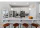 Kitchen island with seating and stainless steel appliances, and white cabinetry at 37045 Scenic Ridge Dr, Grand Island, FL 32735