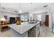 Open-concept kitchen featuring granite countertops, island seating, and a view to the living area at 37045 Scenic Ridge Dr, Grand Island, FL 32735