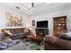 Comfortable living room with couches, a fireplace, and art on the walls at 37045 Scenic Ridge Dr, Grand Island, FL 32735