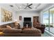 Inviting living room with plush sofas, a ceiling fan, and a sliding glass door to the outside at 37045 Scenic Ridge Dr, Grand Island, FL 32735