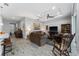 Open-concept living room with wood-look tile floors, ceiling fan, and tray ceiling with recessed lights at 37045 Scenic Ridge Dr, Grand Island, FL 32735