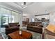 Living area with an open floor plan, sliding glass door, and views into the dining and kitchen areas at 37045 Scenic Ridge Dr, Grand Island, FL 32735