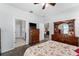 Comfortable main bedroom with furnishings and ceiling fan at 37045 Scenic Ridge Dr, Grand Island, FL 32735
