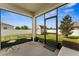 Covered patio with seating, offering an enjoyable view of the backyard and storage shed at 37045 Scenic Ridge Dr, Grand Island, FL 32735