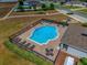Aerial view of a community pool with lounge chairs and picnic area at 37045 Scenic Ridge Dr, Grand Island, FL 32735