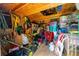 Shed interior is filled with lawn equipment and storage containers, maximizing space at 37045 Scenic Ridge Dr, Grand Island, FL 32735