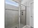 Walk-in shower featuring decorative tile and a rainfall shower head at 37045 Scenic Ridge Dr, Grand Island, FL 32735