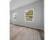 Bedroom with a window view, light walls and wood-look floors at 3978 Sw 151St St, Ocala, FL 34473