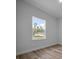Bright bedroom featuring light wood flooring, window view and neutral paint at 3978 Sw 151St St, Ocala, FL 34473