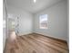 Bright bedroom featuring light wood flooring, view to the en suite bathroom and neutral paint at 3978 Sw 151St St, Ocala, FL 34473