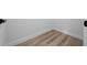 Corner shot of a room featuring baseboards, wood-look floors and white walls at 3978 Sw 151St St, Ocala, FL 34473