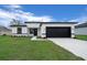Attractive single-story home with a well-manicured lawn and a contemporary black-and-white exterior design at 3978 Sw 151St St, Ocala, FL 34473
