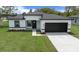 Charming single-story home showcasing a well-maintained lawn and a modern black-and-white color scheme at 3978 Sw 151St St, Ocala, FL 34473