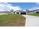 Charming one-story home exhibiting a manicured lawn and a stylish black-and-white color palette at 3978 Sw 151St St, Ocala, FL 34473